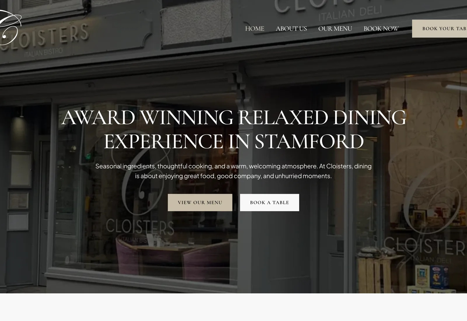 The Cloisters Stamford homepage on a desktop browser: the headline “Award Winning Relaxed Dining Experience In Stamford” over a photograph of the restaurant frontage, above “View Our Menu” and “Book A Table” buttons.